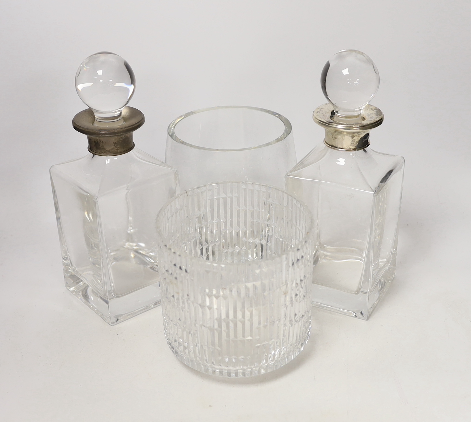 A pair of silver collared decanters and stoppers and two glass vases, decanters 26cm